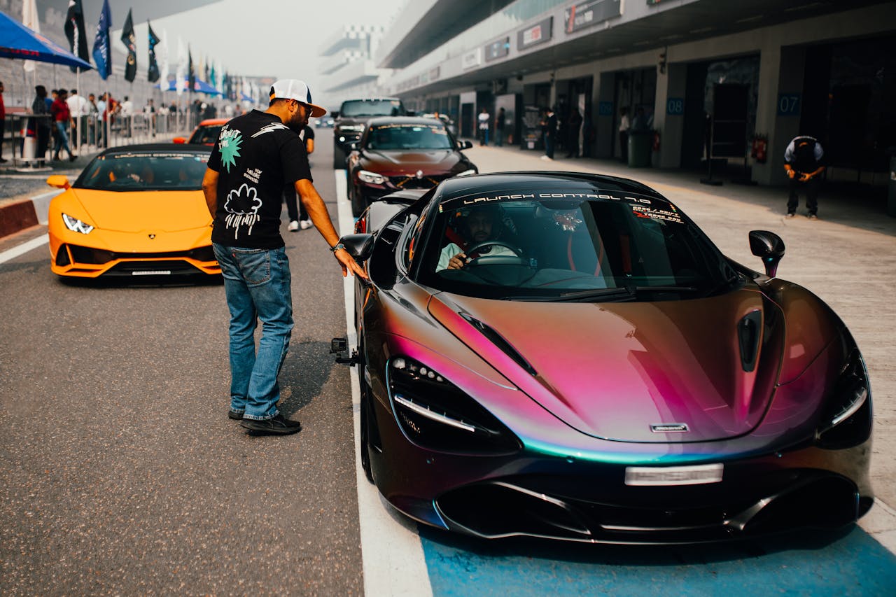Dynamic scene featuring sports cars on a racing track in Greater Noida, India.